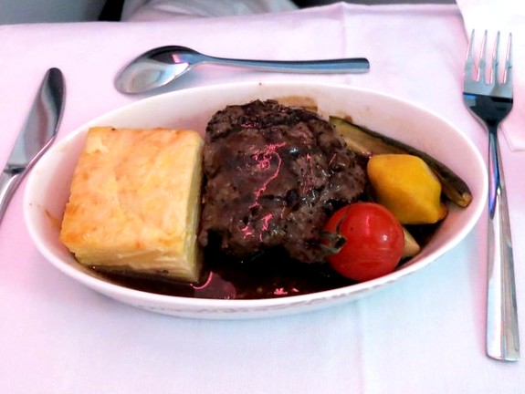 The main entree. A filet with potatoes and vegetables.