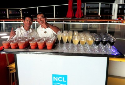 Norwegian Getaway bartenders serving drinks at the past guest party.